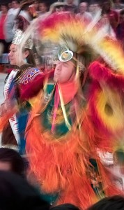 Indoor image at a pow wow, an example of a somewhat long shutter speed, about a 1/15th of a second, used to illustrate motion
