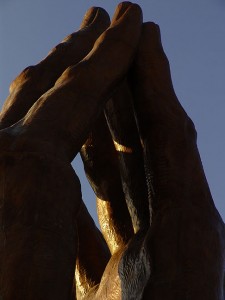 The 30-ton bronze "Praying Hands" sculpture at Oral Roberts University, in maturing afternoon light. 