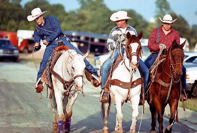 Rodeo cowboys ride into the show arena, June 1996. I found this image while searching my archives for another item, and thought it deserved another moment in the light.