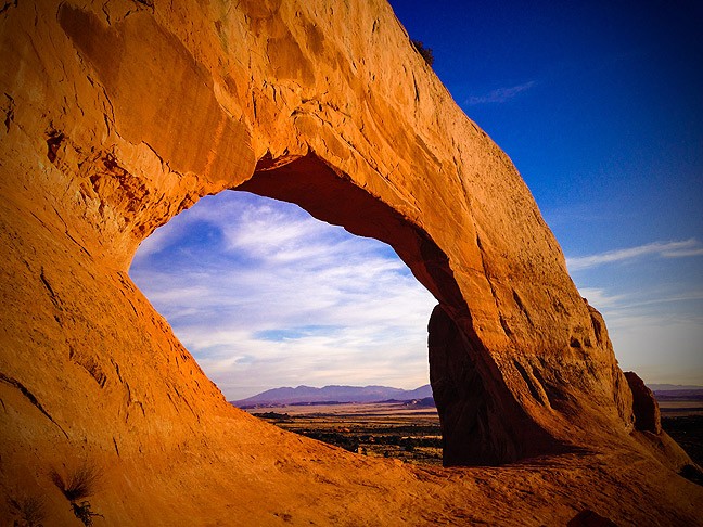I shot this image of Utah's Wilson Arch with my iPhone for the sole purpose of posting it to PhotoLoco. I used Photoshop Express to punch up the colors and darken the corners, which gave the image a far better sense of drama.