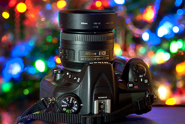 The tools of the holiday trade: a digital SLR, a lens with a nice, large maximum aperture, and my own elegantly decorated Christmas tree. The lens is one of my favorites, Nikkor's AS-S 35mm f/1.8.