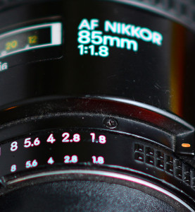 This is classic spherochromatism, as you can see in this image of my old 85mm: the close numbers on the aperture ring have a red cast, and the far letters on the lens barrel are green. This aberration is common to large-aperture lenses.