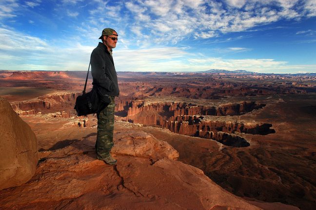 The author stands at the edge of a 1200-foot cliff face at Grand View Point in the Island in the Sky District of Canyonlands National Park, Utah in April 2011.