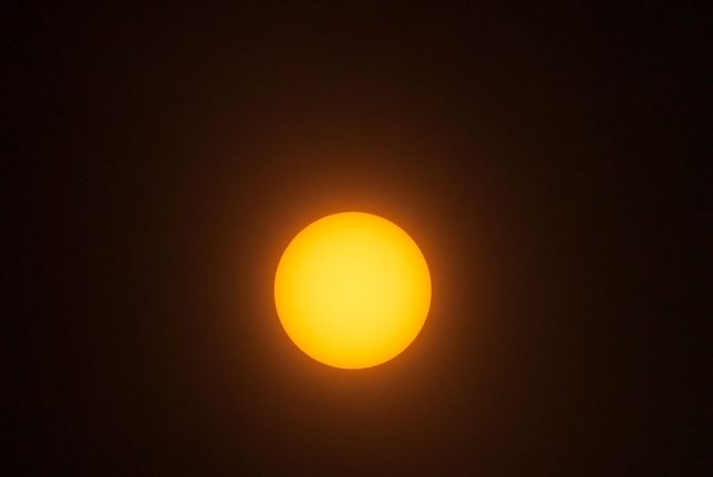 This is a test image of the sun I made today under hazy skies, shot with my 400mm f/3.5 Nikkor, my 1.4x Nikon teleconverter, and a small piece of "eclipse glasses" film on the 39mm drop-in filter in the lens.