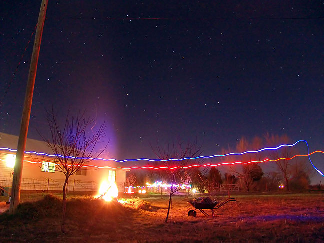 Our fire, the Christmas lights in the front yard, a number of stars, and traces from our flashlights are visible in this 30-second exposure tonight.
