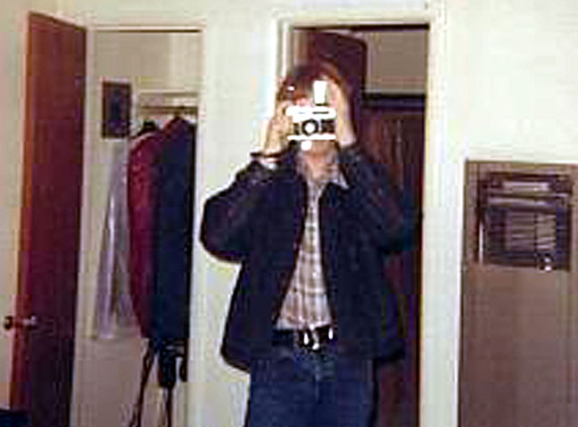 Denim jacket, plaid shirt, and camera; the essence of me in high school.