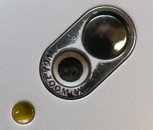 The Motorola Rokr didn't have the display and the camera on the same side of the unit, so this tiny, round mirror was installed on the camera side for composing selfies.