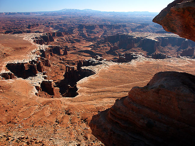 This image shows Monument Basin from the White Rim Overlook with the Abajo Mountains in the distance.
