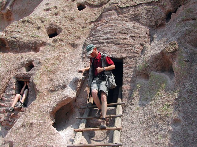 Your host emerges from one of the cliff dwellings open to the public at Bandeiler.