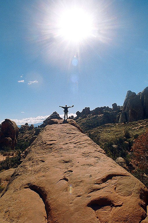 The author stands at the end of a sandstone fin in the Devil's Garden section of Arches National Park, Utah.