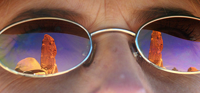 The Dark Angel spire, at the end of a spur trail on Arches' Primitive Loop trail, is shown in Abby's sunglasses.