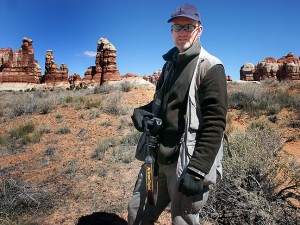 The author hikes in the cold at Chesler Park, Canyonlands. I made this image by hanging one of my cameras from a juniper branch.