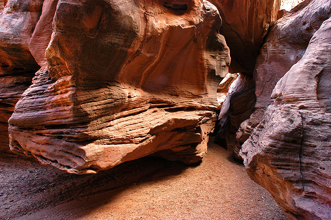 The trail passes under the boulder jammed in the crack to the right.