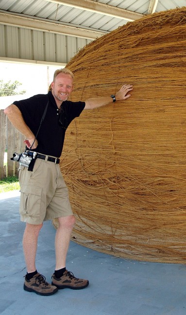 The author leans on the world's largest ball of sisal twine in Cawker City, Kansas. As Abby pointed out in a video clip from the day, "This is not a haystack."