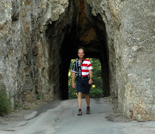 The author walks through "The Keyhole," a tunnel on the Needles Highway in Custer State Park, South Dakota.