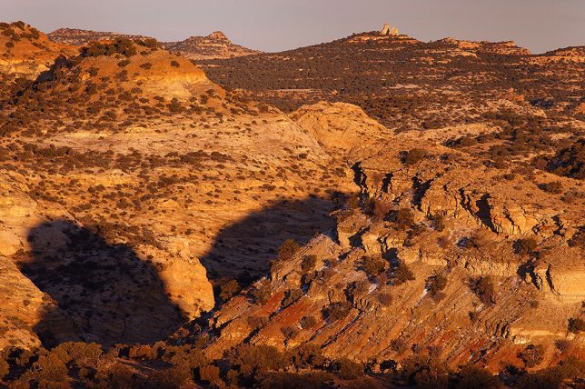 The San Rafael Swell takes on a deep amber tone as sunset approaches.