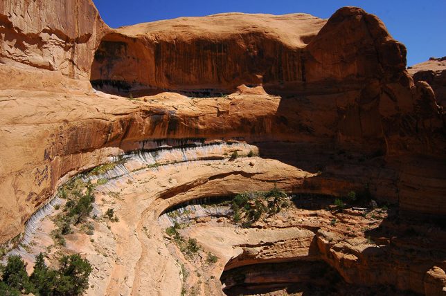 The Corona Arch trail follows a deeply-contoured cliff.