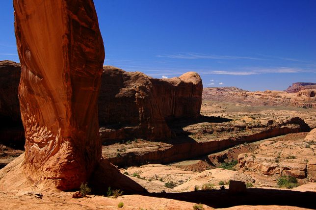 This view from directly under Corona Arch looks west toward the trail head. The cut for the rail line is visible.