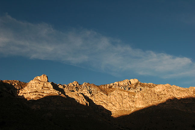 A late afternoon shadow creeps up on cliffs on the Devil's Hall trail, Guadalupe Mountains.