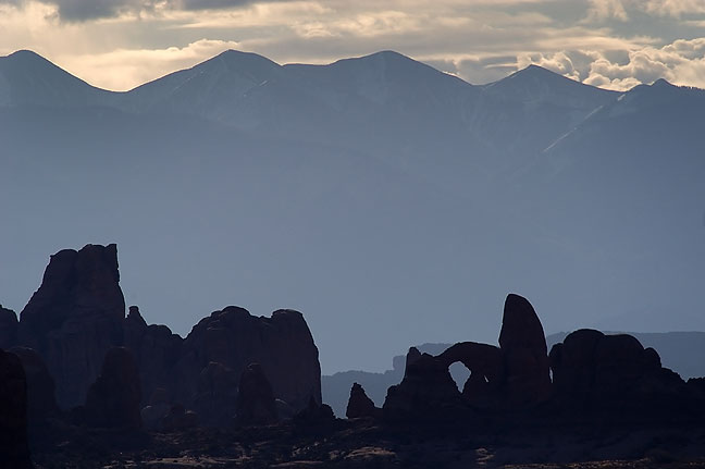 The La Sal Mountains and Turret Arch, viewed from the Klondike Bluffs section of Arches National Park, Utah.