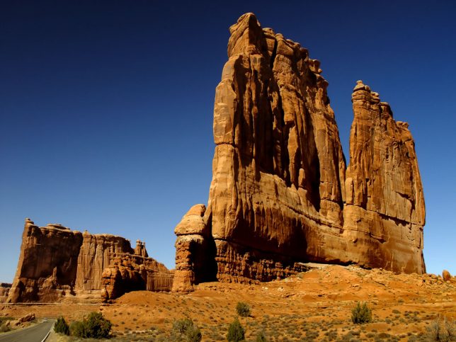 The Courthouse Towers stand tall on the main road at Arches National Park.