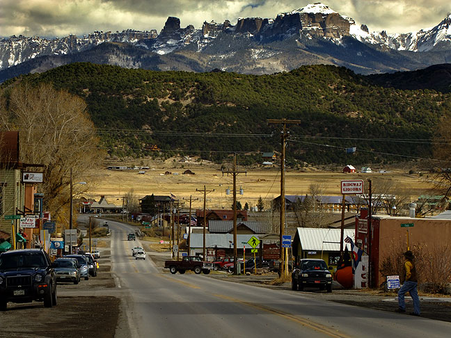 Looking down the main highway in Ridgeway, the first peaks of the spectacular San Juan Mountains appear in the distance.