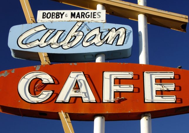 A café signs in Cuba, New Mexico stands in magnificent autumn sunshine.