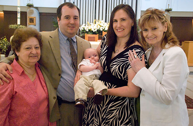 Tom and Chele with their mothers proudly hold Paul Thomas after his Christening.