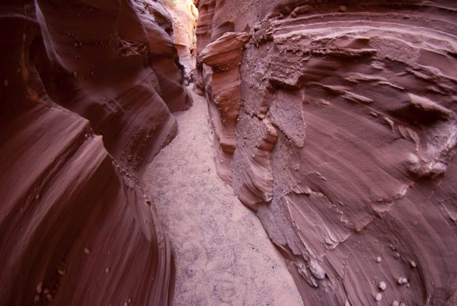 Deep in Waterholes Canyon I found walls covered in moki marbles.