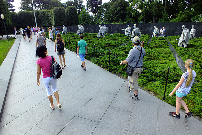 Approaching the Korean War Memorial, visitors appear to walk alongside the soldiers depicted.