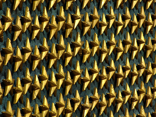During World War II, families of those serving displayed flags with blue stars. If that service person died, the star was changed to gold. This display at the Memorial, the The Freedom Wall, has 4,048 gold stars, each representing 100 Americans who died in the war. In front of the wall lies the message "Here we mark the price of freedom".
