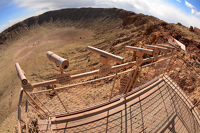 Spotting scopes sit mounted on a visitor's platform overlooking Meteor Crater in Arizona.