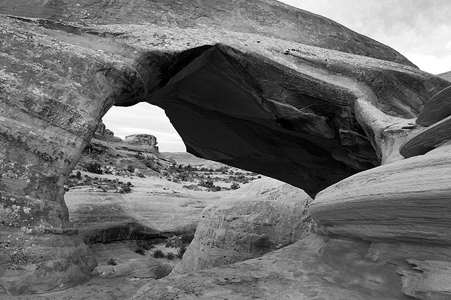 Echo Arch, across a small canyon from Delicate Arch, is difficult to photograph because it is hard to find a position from which you can see daylight through the opening. I had to lie down to get this frame.