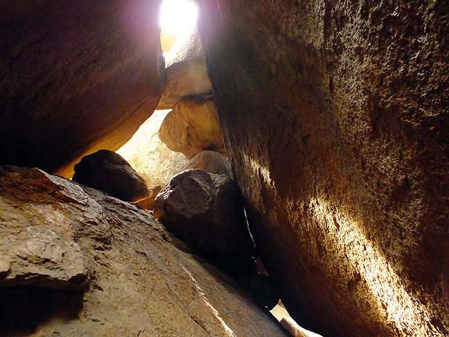 Sunlight streams through cracks in a cave formed by a rockfall on the Charon's Garden Wilderness Area in the Wichita Mountains Wildlife Refuge in southwest Oklahoma.