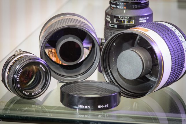 The Reflex-Nikkor 500mm f/8 lens, second from the left, sits in the company of a 50mm f/1.4, an 85mm f/1.4, and a 500mm Opteka mirror lens.