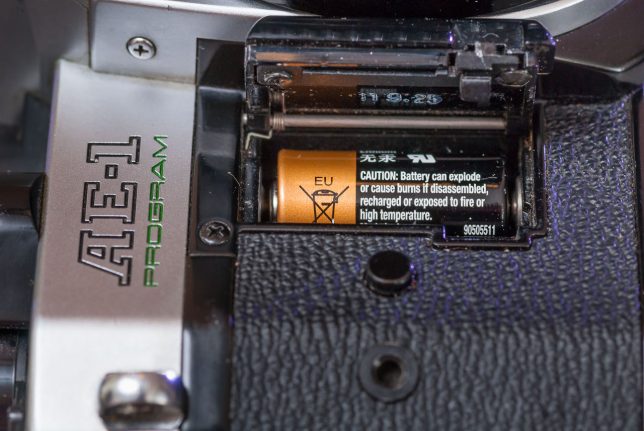 The battery for the Canon AE-1 Program sits inside a door on the front of the camera.