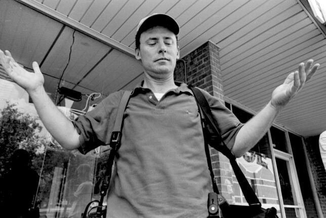 Robert throws up his hands as he and I make pictures in downtown Ada in the late 1990s.