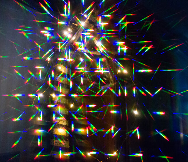 The diffraction grating filter was a popular screw-on special effect filter in the 1970s and 1980s, but they have mostly fallen out of favor. I made this image not with a screw-in filter, but through a pair of paper glasses I got at an attraction in Las Vegas last year, and hung on to them in hopes of using them to illustrate something. Does this image look fake? In most ways, it definitely is. 