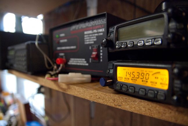 One thing that makes working outside more fun for me is my recent addition of a scanner/ham radio stack and a music system above my workbench.