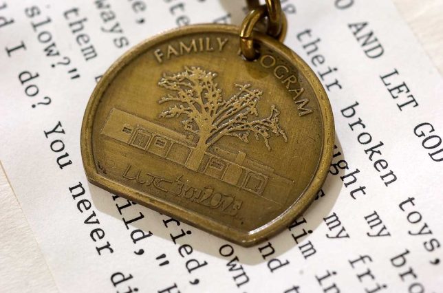 This key fob was "that little souvenir." Family members of the clients all got one. For this photo, it is sitting on a "God bag," which bore the "serenity prayer." The idea is to write down your problems, thus "giving them to God."
