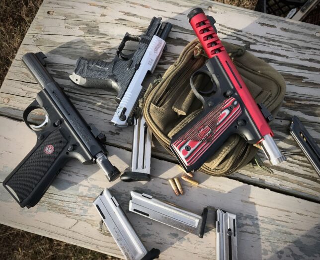 Our Ruger 22/45 Target, Walther P22, and Ruger 22/45 Lite sit on the bench at our range in the back pasture this afternoon.