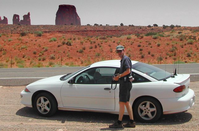 The author returns to the car after stopping by the side of the road in Monument Valley.