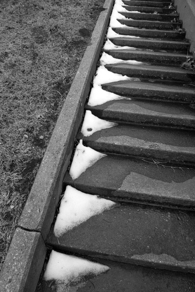 A slightly-melted trace of snow is visible on stairs in this image at the dam.