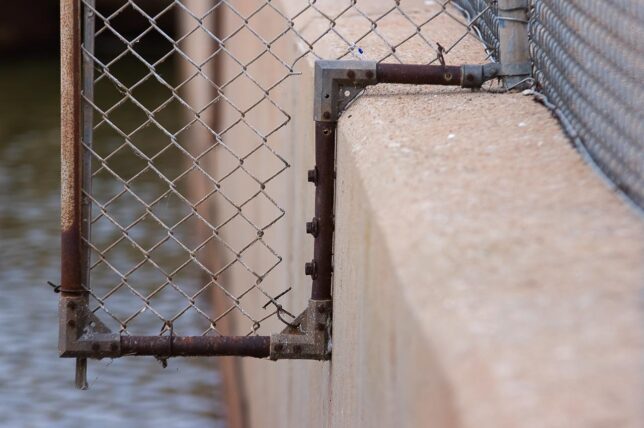 A chain link fence keeps you from walking too far out on the spillway.